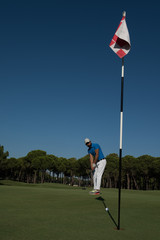 Obraz premium golf player hitting shot at sunny day