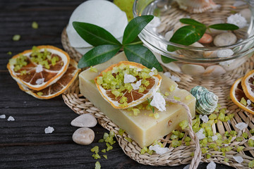 Composition of spa treatment with green salt and soap on wooden