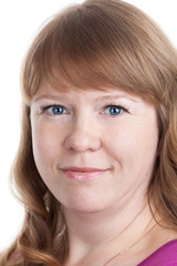 Facial portrait of smiling Caucasian woman with curly hair and blue eyes, isolated on white background