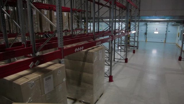 Camera moves between palettes with boxes warehouse