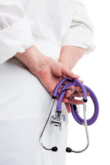 Close up view of doctors hands holding stethoscope behind back, isolated on white background
