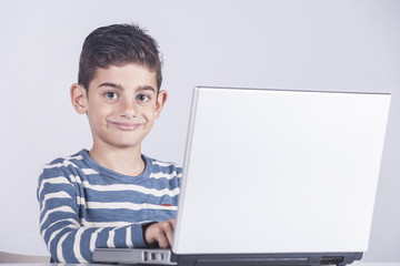 Young boy using a laptop computer (e learning concept)