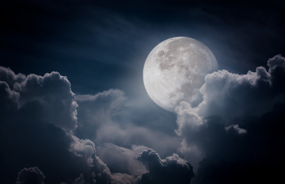 Nighttime sky with clouds, bright full moon would make a great background.