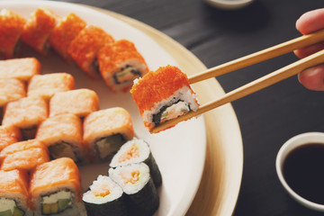 Eating sushi rolls at japanese food restaurant