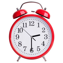 Red alarm clock shows half past two