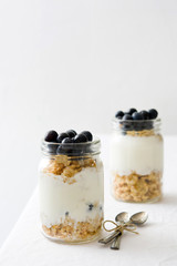 Yogurt with blueberries on white table
