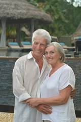 elderly couple rest at tropical resort