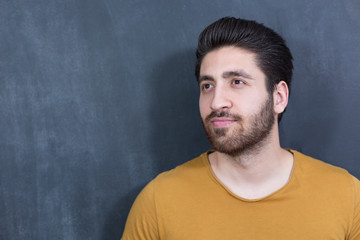 Obraz premium Attractive young man against blackboard.