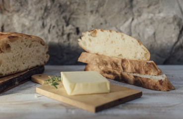 Pieces of rustic round loaf bread with butter