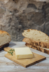 Pieces of rustic round loaf bread with butter