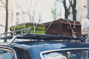 Vintage suitcase on an old car roof rack. 