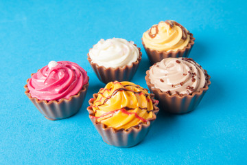 Birthday cupcakes on blue background. many sweet  cupcakes