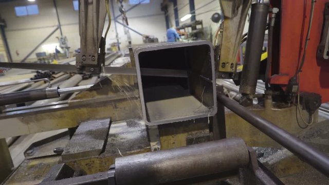 Water dripping out to the machine while sawing. The metal sawer machine cuts out a portion of the metal