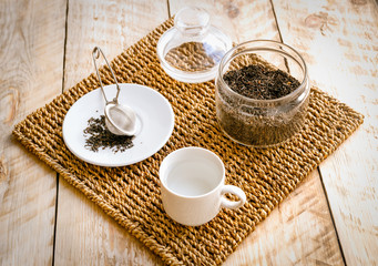 Fototapeta na wymiar Tea on wicker mat at home wodden table backround