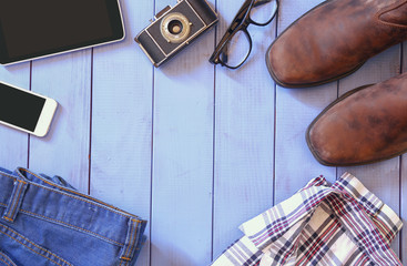 top view image of hipster accessories and clothes a wooden backg