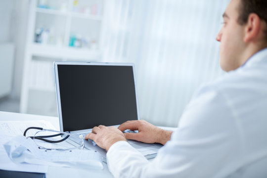 Doctor typing on the computer