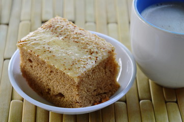 cake and milk coffee on bamboo plate