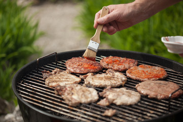 Burgers and steaks on BBQ grill
