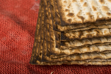 Matzah - jewish passover bread on red burlap

