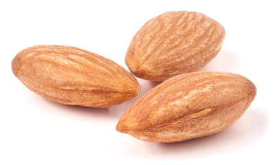 Three almonds isolated on white background macro