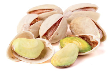 some pistachios on a white background close up