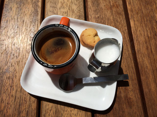 single espresso with milk and cookie