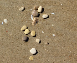 Fototapeta na wymiar Stones on the sand beach top view