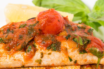 Grilled dorado covered with baked vegetables