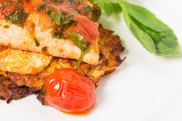 Grilled dorado covered with baked vegetables