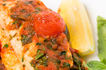 Grilled dorado covered with baked vegetables
