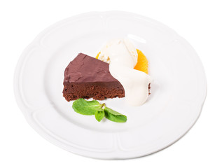 Chocolate cake with ice cream scoop.