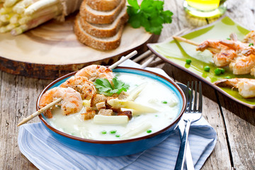 Frische Spagelcreamsuppe serviert mit garnellenspies 