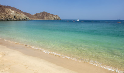 Fototapeta na wymiar sea scene with sand bech and emerald water in united arab emirate