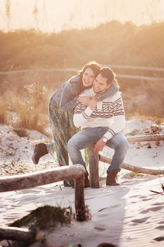 Lovely young couple on the sunset beach, selective focus and toned image