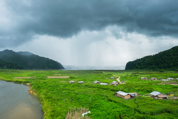 River lake village cultivate wayside straight mountain raining storm nature sprints at Rantee river