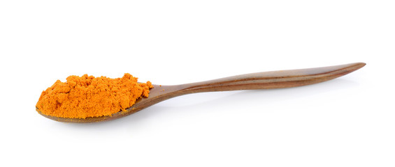 turmeric in the spoon on white background