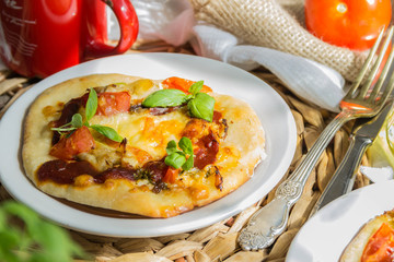 Tasty pizza with vegetables and basil on wooden table