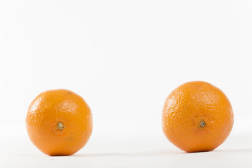 Closeup on Orange Clementines in Bright Studio