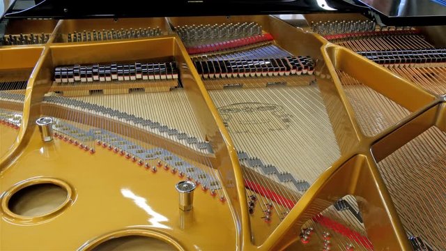 The back of the old piano with the piano strings of the instrument