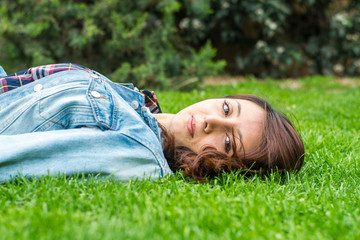 beautiful young woman resting on the grass