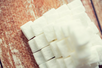 close up of white sugar pyramid on wooden table