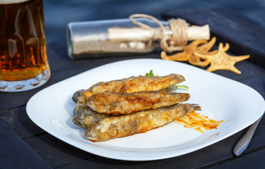 Fried fish gobies in batter with greens