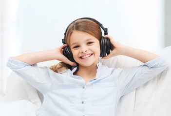 smiling girl with headphones listening to music