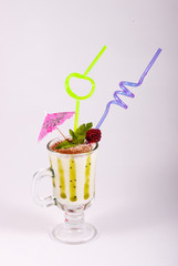 Milkshake in a glass decorated with berry, chocolate and mint