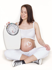 Pregnant woman with scale