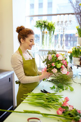 smiling florist woman making bunch at flower shop - obrazy, fototapety, plakaty