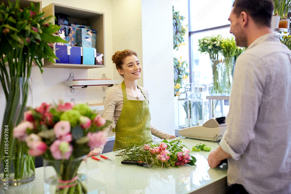 Canvas Prints smiling florist woman and man at flower shop