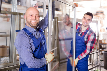 Two smiling workmen at factory