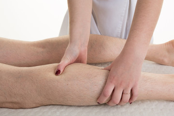Young woman receiving a leg massage in a health club