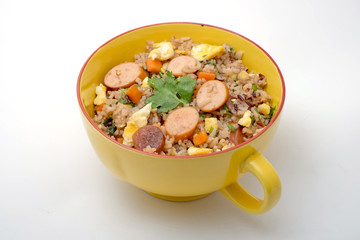 Fried rice with sausage and vegetables on white background